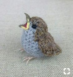 a small stuffed bird sitting on top of a table