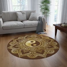 a living room with a couch, chair and rug on the wooden floor next to a window