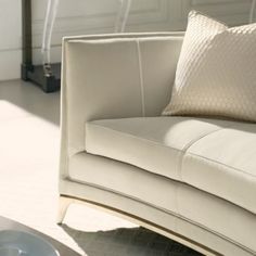 a white couch sitting on top of a hard wood floor