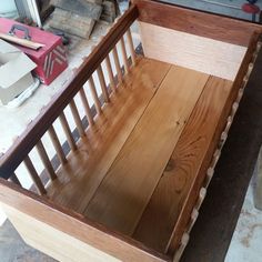 a baby crib is being made in a workshop