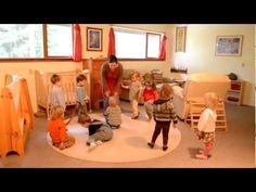 a group of children standing around in a room with bunk beds and cribs