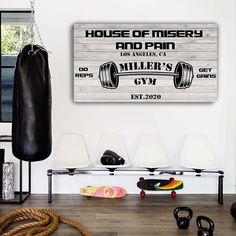 a gym room with a sign that says house of mystery and an image of a barbell