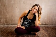 a woman is sitting on the floor and smiling