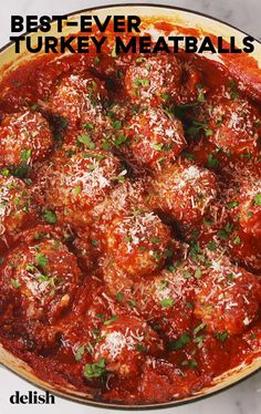 meatballs covered in marinara sauce and parmesan cheese