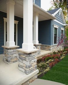 a house with blue siding and white pillars