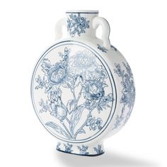 a blue and white vase with flowers on it