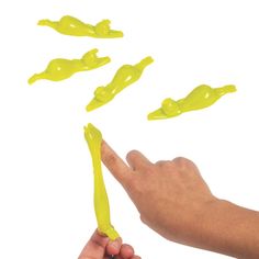 a hand is reaching for yellow plastic objects