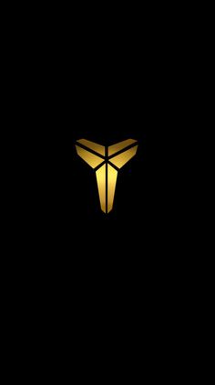 the letter t is illuminated in gold on a black background, with an arrow symbol