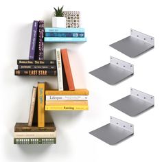 books are stacked on top of each other in the shape of a book shelf with four different sized books