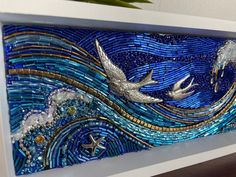 a painting made out of glass with birds flying over the ocean and stars in the sky