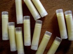 several white candles sitting on top of a table next to each other with one candle in the middle