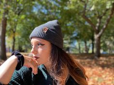 Give the gift of warmth and style! This knit beanie is perfect for hiking, camping, and perfect for keeping warm! Beanie is a dark charcoal gray color, and is made of a soft wool/acrylic blend. Attached is an engraved leather label tag with a brass rivet. The leather label is engraved on both sides, so whether you wear the hat with the brim up or down, the label will still show the design in the correct orientation. Choice of circle logo or trees available at checkout. Care - Hand wash, dry flat Warm Beanie For Outdoor, Warm Beanie For Fall And Winter, Warm Winter Beanie For Fall, Adjustable Warm Beanie For Outdoor, Warm Adjustable Beanie For Outdoor, Adjustable Warm Gray Beanie, Outdoor Beanie Cap, One Size Fits Most, Warm Outdoor Hat One Size, Black Casual Beanie For Outdoor Activities