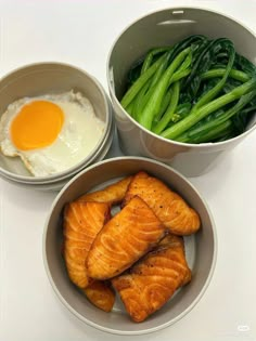 three bowls filled with food on top of a white countertop next to green beans and an egg