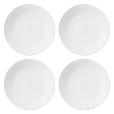 four white plates sitting side by side on top of each other in the shape of circles