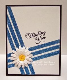 a blue and white card with a flower on it