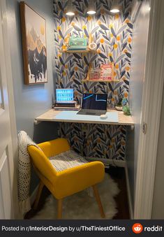 a yellow chair sitting in front of a desk with a laptop on top of it