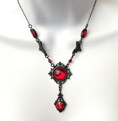 Black and Red Crystal Gothic Victorian necklace Vampress Red and Black Necklace Halloween Necklace Bat Necklace This is definitely a statement necklace! Featuring very rare 1928 black pewter centerpiece mount with Red crystal cabochon. Along the chain are fabulous Black Pewter lead free bats from Tierracast and lovely high quality navettes. From the beautiful 1928 hardware mount is a black brass drop with a gorgeous faceted red rivoli! The chain is a delicate figaro with a lobster claw clasp and Halloween Parties, Red And Black Necklace, Vampire Jewelry, Bat Necklace, Victorian Necklace, Halloween Necklace, Gothic Victorian, Jewellery Ideas, Victorian Gothic