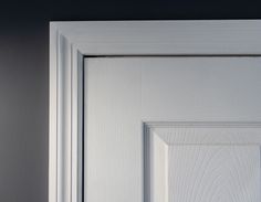 an open white door with a black handle