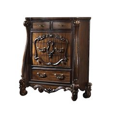 an ornate wooden cabinet with two drawers and carvings on the front, in dark wood