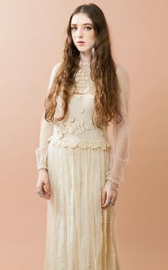 a woman wearing a white dress with long hair