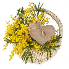 a basket filled with yellow flowers and a wooden heart