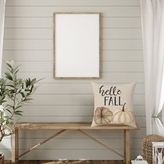 a wooden bench with a pillow on it next to a white wall and a plant