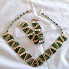 two pieces of beaded jewelry on a white sheet