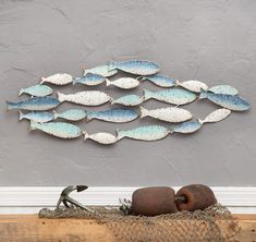 a large metal fish sculpture sitting on top of a wooden table