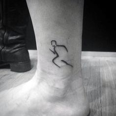 a black and white photo of a person's foot with a small tattoo on it