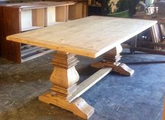 a wooden table sitting on top of a blue carpeted floor