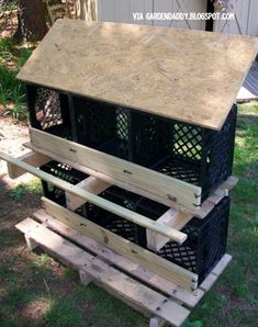 three crates stacked on top of each other in the grass