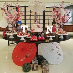 a table topped with lots of desserts and umbrellas