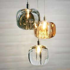 three lights hanging from a ceiling in a room