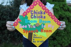 a person holding up a sign that says chicken chicka boom boom see you in my speech room