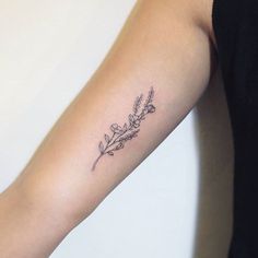 a woman's arm with a tattoo that has flowers on it and the word love written in cursive writing