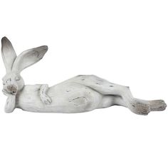 a white statue of a rabbit laying down