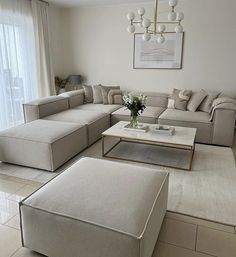 a living room filled with furniture and a chandelier