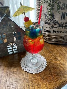 a colorful drink sitting on top of a wooden table