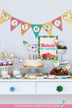 a table topped with cake and cupcakes next to a sign that says mahou is coming