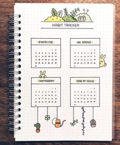 a spiral notebook with an image of rabbits and plants on the page, which reads habit tracker