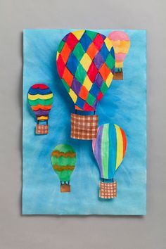 colorful hot air balloons in the sky on blue paper