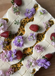 a cake with strawberries and flowers on it