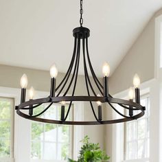 a chandelier with six lights hanging from the ceiling in a dining room area