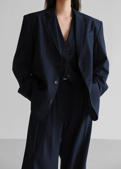 Color: Navy Pinstripe Midweight traditional suiting fabric Oversized silhouette Padded shoulders Flap front pockets Button front closure Lined 72% Polyester 22% Rayon 4% Wool 2% Spandex Dry Clean By The Frankie Shop. Imported One Size Product Measurements: 20" Shoulder 46" Bust 30" Length Model is wearing size O/S Navy Pinstripe Suit Women, Gender Fluid Formal Wear, Pinstripe Suit Women, Suit Aesthetic, Stripe Suit, Tailored Vest, Striped Suit, Striped Vests, Tailored Suit