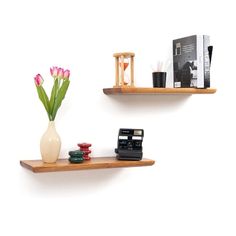 two wooden shelves with flowers and other items on them