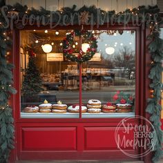 a red store front with christmas decorations and cakes in the window, behind which are wreaths