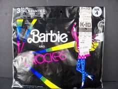 a package of barbie hair and rock'n'roll toys on a black surface