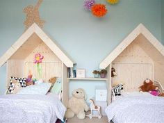 there are two beds that have been made to look like children's houses with stuffed animals on them