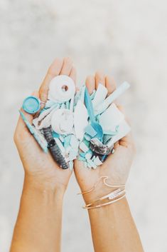 two hands holding various items that have been thrown into the air and are being held by one hand