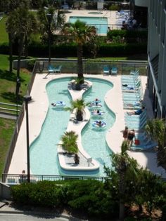 an aerial view of a swimming pool with people in it